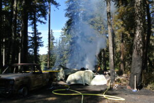 Dousing the ground, cooling the debris by Jenny Chissus